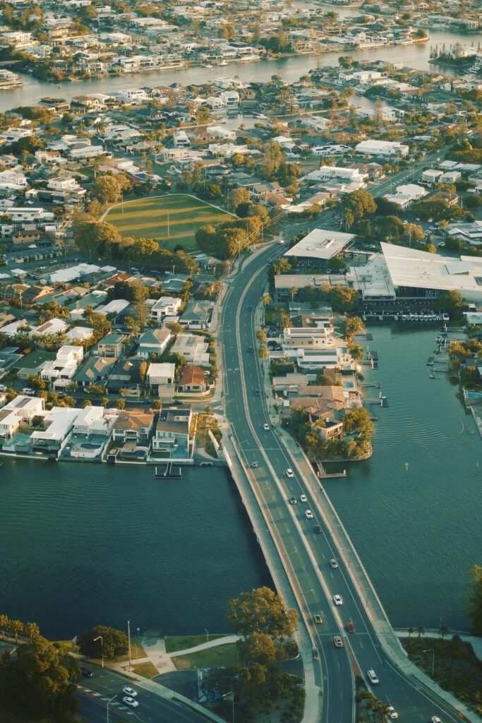 Scenic aerial shot showcasing a suburban area with a bridge and waterways in daylight.