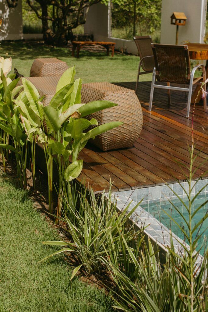 Relaxing outdoor deck with poolside seating and tropical plants in Bahia, Brazil.