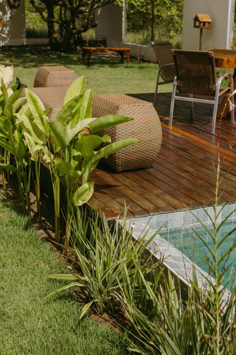 Relaxing outdoor deck with poolside seating and tropical plants in Bahia, Brazil.